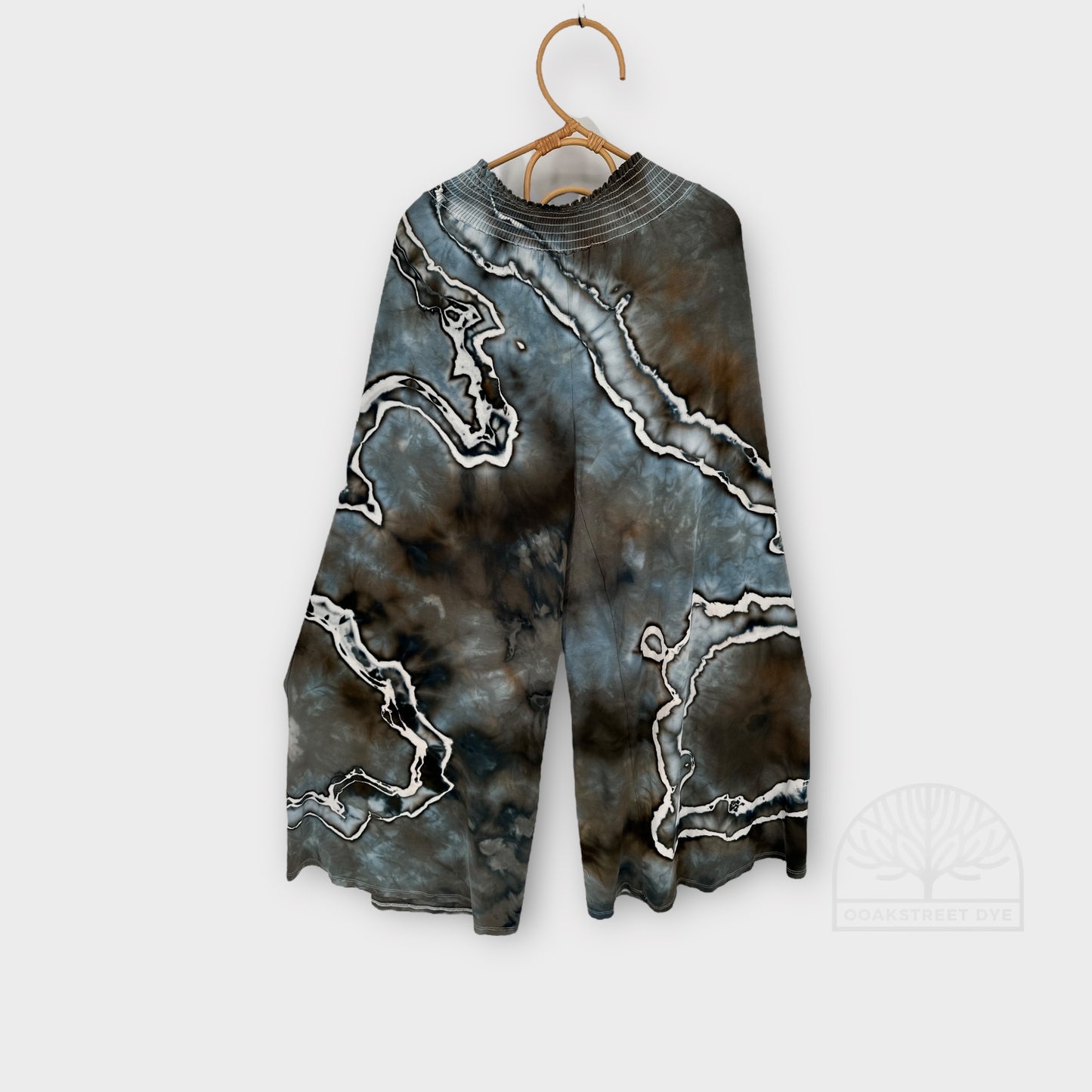 Close-up of Driftwood palazzo pants, hand-dyed bamboo viscose fabric with blue-gray, charcoal, and weathered brown marbling.