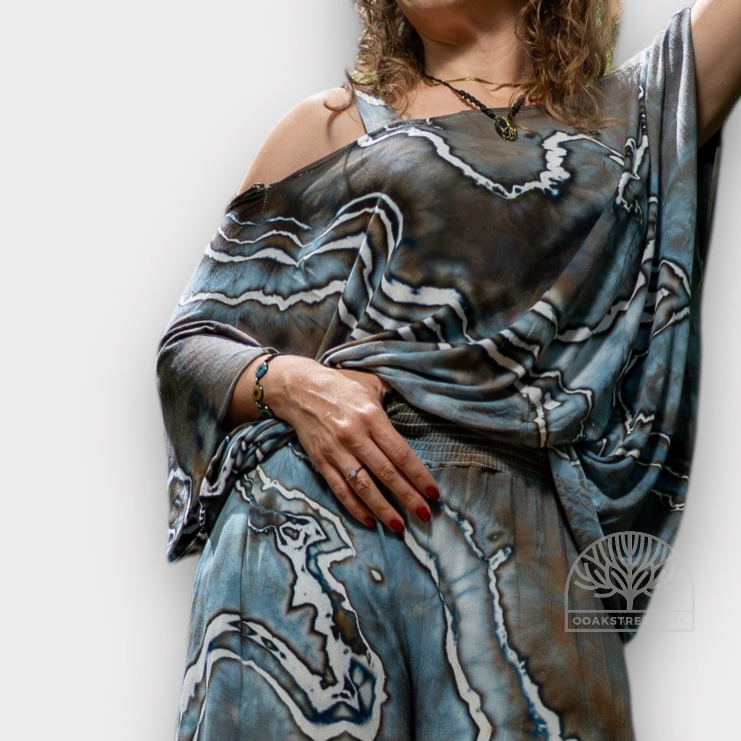 Close-up of Driftwood palazzo pants and twist top set, hand-dyed bamboo viscose fabric with blue-gray, charcoal, and weathered brown marbling.